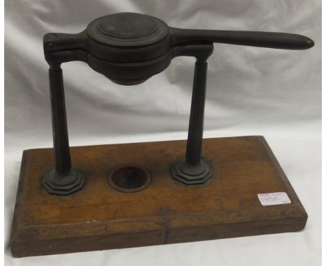 A Victorian lemon squeezer by W Thornhill & Co on an oak base (Rg. No. 18472)