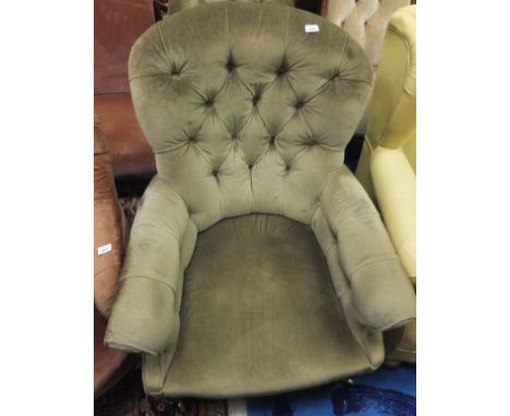 A Victorian mahogany button back armchair on turned front legs