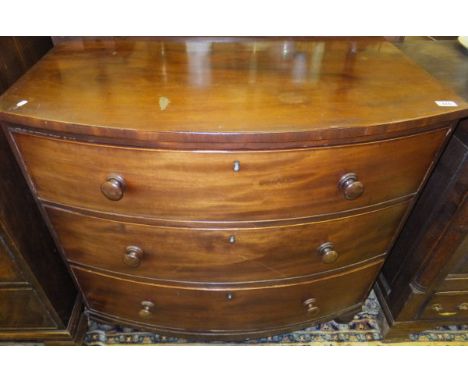 A 19th Century mahogany bow fronted chest of three long drawers on turned feet
