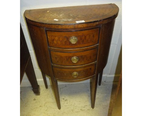 An early 20th Century demi lune side table with marquetry decoration, with three drawers, on square tapering legs