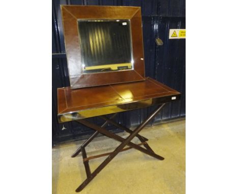 A modern metal framed and leather covered butler's tray style side table on X-frame base, with matching wall mirror