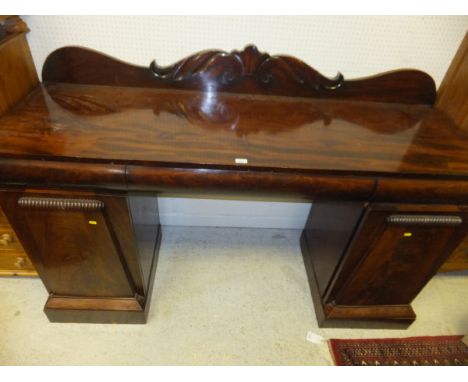 A late Regency/William IV mahogany pedestal sideboard, the raised foliate decorated back over three cushion drawers on two ar