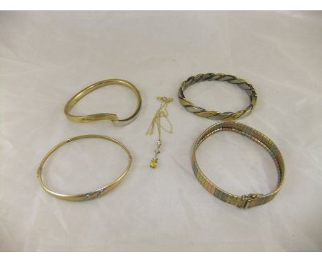 A 9 carat tri-colour gold bracelet, a gold and diamond set bangle, a bi-colour bangle, and a 9 carat gold dome set pendant CO