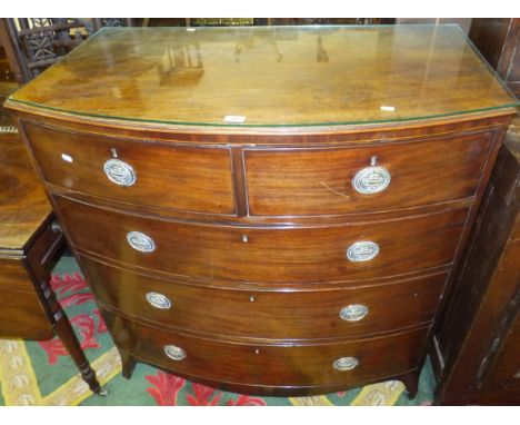 A Regency mahogany bow fronted chest of two short and three long graduated drawers on splayed bracket feet