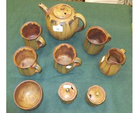 A collection of studio pottery wares by Jeff Jelfs of Bourton-on-the-Water to include teapot, four mugs, sugar bowl, milk jug