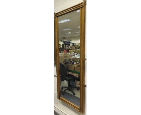 A modern oak framed full length wall mirror, and a blue painted shelf