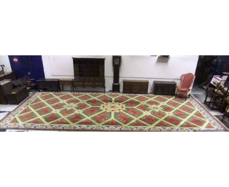 A large wool carpet in the 18th Century French taste by Stockwell Carpets, the centre field with diamond shaped design border