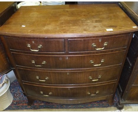 A Regency style mahogany bow fronted chest of two short and three long drawers on spade feet