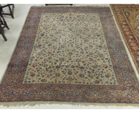 A Tabriz carpet, the cream centre field with all over repeating stylised foliate decoration in terracotta, blue and mustard w