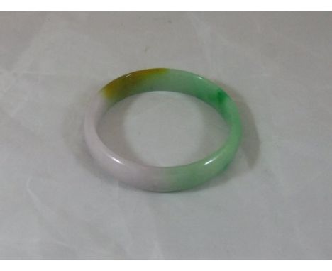 A jade bangle CONDITION REPORTS Overall with some general wear and scuffs, internal diameter of bangle approx. 6.25 cm.