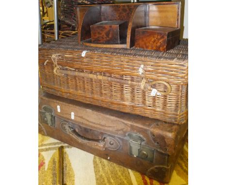 A brown leather suitcase marked "E.P.C", a wicker hamper, a book trough with two small boxes