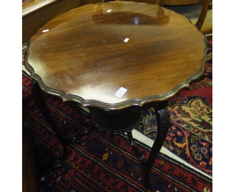 A 19th Century mahogany occasional table, the cabriole legs with leaf carved decoration united by a central shelf