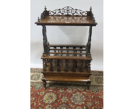 A WILLIAM IV ROSEWOOD CANTERBURY TABLE, the rectangular top with foliate pierced raised sides and ring turned finials, on lyr