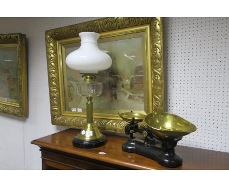 A BRASS AND GLASS MOUNTED OIL LAMP, with white opaline shade; together with a cast iron and brass "Libra" weighing scales wit