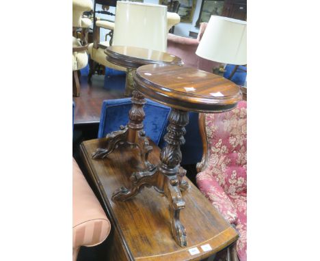 A PAIR OF VICTORIAN STYLE MAHOGANY FRAMED OCCASIONAL TABLES, with circular tops with moulded rims raised on foliate carved ce