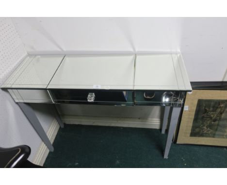 A CONTEMPORARY RECTANGULAR CONSOLE TABLE, the bevelled mirrored top and frieze with a single drawer on grey painted square cu