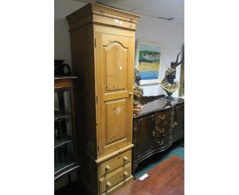 A RECTANGULAR PINE SINGLE DOOR WARDROBE, above two short drawers on plinth base, 200cms x 59cms x 54cms