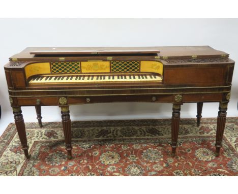 A REGENCY MAHOGANY AND MARQUETRY INLAID SPINNET of typical form the hinged section opening to reveal stainwood painted panels