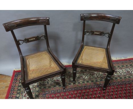 A SET OF SIX REGENCY MAHOGANY DINING CHAIRS each with a curved top rail and plain  seats on reeded and ring turned legs 