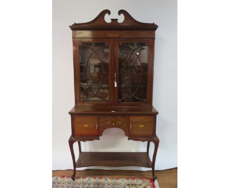 AN EDWARDIAN MAHOGANY AND MARQUETRY INLAID DISPLAY CABINET, BY EDWARDS & ROBERTS, the broken swan neck pediment inlaid with f