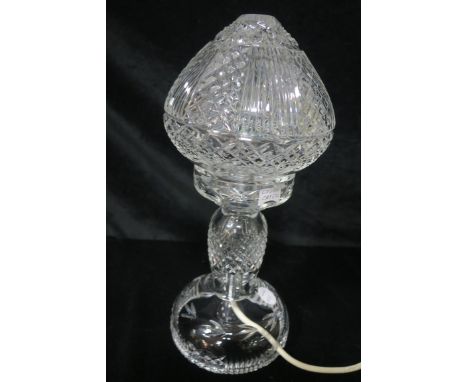 A CAVAN CRYSTAL CUT GLASS TABLE LAMP, the fluted and diamond cut shade raised on a waisted column with circular domed base.