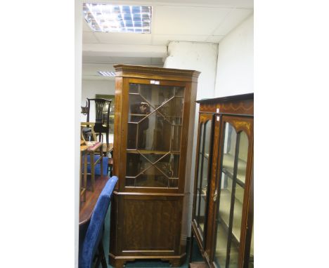 A MAHOGANY CORNER CABINET, with satin inlay and astragal glazed doors,the base with cupboards on breakfront feet 200cms x 84c