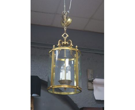 A GEORGIAN STYLE GILT BRASS FOUR LIGHT HALL LANTERN, with glazed panelled sides.