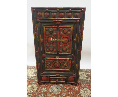 AN ORIENTAL PINE AND POLYCHROME SIDE CABINET, with cupboards and drawer decorated with paterae roundels on moulded base,119cm