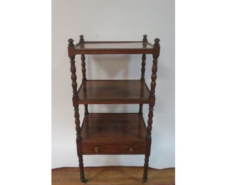 A MAHOGANY FRAMED THREE TIER WHAT-NOT the rectangualr open shelves with raised rims between ring turned supports with a singl