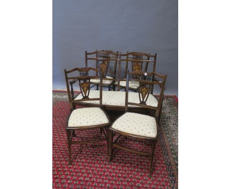 AN EDWARDIAN MAHOGANY AND MARQUETRY INLAID DRAWING ROOM SUITE, comprising a two seater sofa two armchairs and four single cha