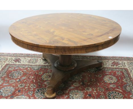 A VICTORIAN ROSEWOOD CENTRE TABLE, the circular top with a recessed frieze raised on a tapering pod with tripod platform base