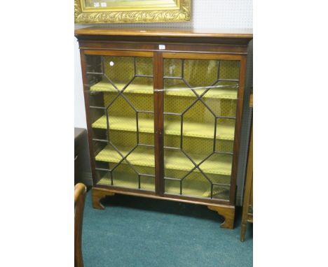 AN EDWARDIAN MAHOGANY FRAMED DISPLAY CABINET, the rectangular top above a pair of astragal glazed doors revealing lined shelv