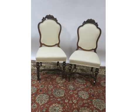 A SET OF FOUR CONTINENTAL IN 18TH CENTURY STYLE DINING ROOMCHAIRS the shaped upholstered backs with moulded rims and headed b