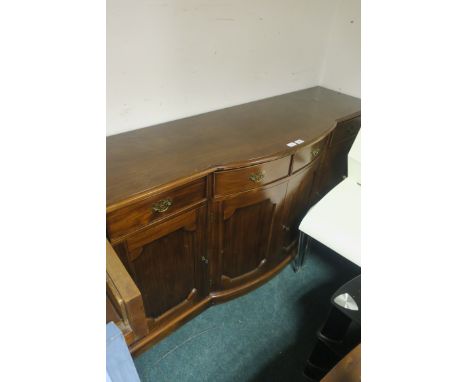 A GEORGIAN STYLE MAHOGANY SIDE CABINET, of rectangular bowed outline, with frieze drawers and cupboards, on platform base,87c