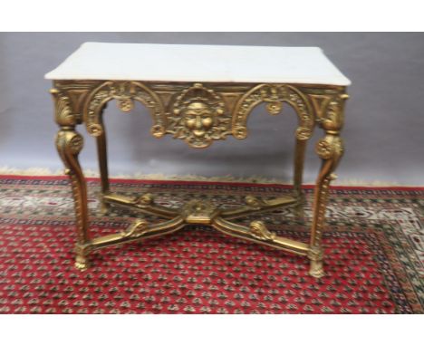 A CONTINENTAL STYLE CONSOLE TABLE, the rectangular white marble top with moulded rim and rounded corners above the shaped fol