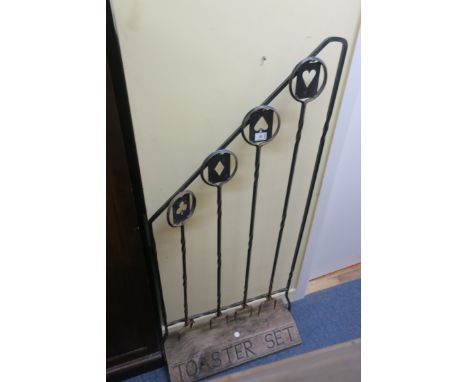 AN EARLY 20th CENTURY METAL FRAMED STANDING "TOASTER SET", the open tubular frame fitted with four double pronged forks, the 
