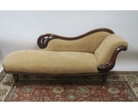 A 19TH CENTURY MAHOGANY FRAMED CHAISE LONG the moulded and scrolled frame with upholstered back, side and seat on ring turned