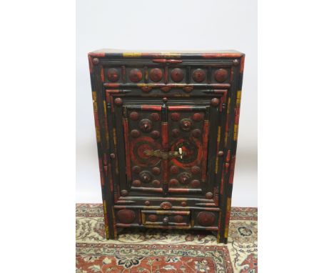 AN ORIENTAL PINE AND POLYCHROME SIDE CABINET, with cupboards and drawer decorated with paterae roundels on moulded base,100cm