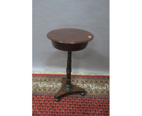 A 19TH CENTURY MAHOGANY WORK TABLE, the circular hinged top lifting to reveal an open interior raised on a ring turned pillar