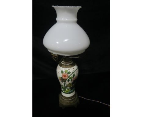 A GLAZED PORCELAIN TABLE LAMP, of circular tapering form the white ground decorated with foliate motifs headed by a opaline d
