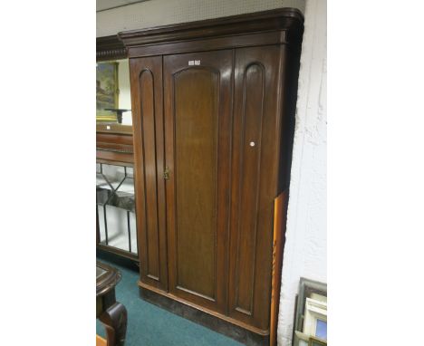 A VICTORIAN MAHOGANY WARDROBE, the moulded cornice above a single panelled door flanked by oval panels, with fitted interior 