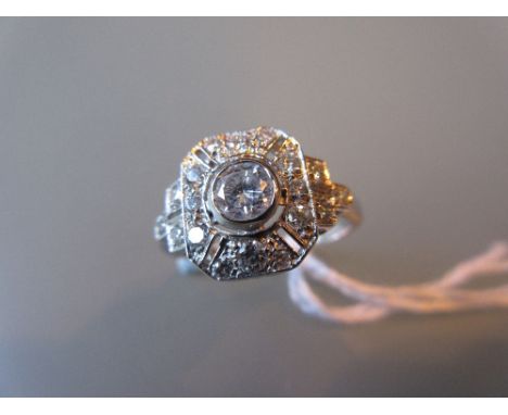 Art Deco style diamond dress ring of irregular pierced octagonal design, the centre stone with smaller diamond surrounds and 