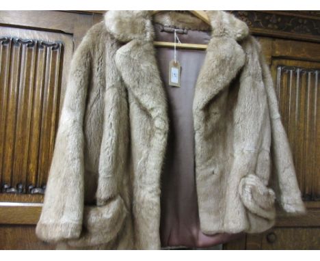 Ladies short light coloured fur jacket