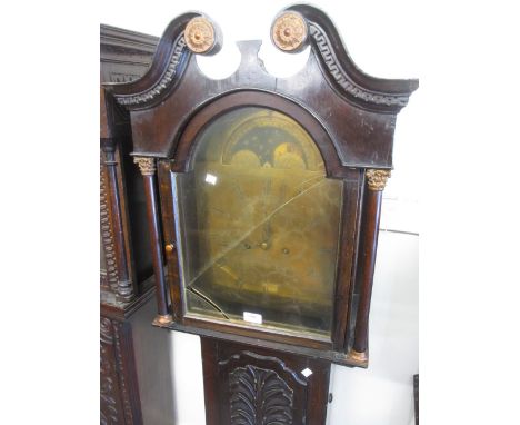 Carved oak longcase clock, the broken arch hood with swan neck pediment and flanking pilasters above a shaped panel door and 