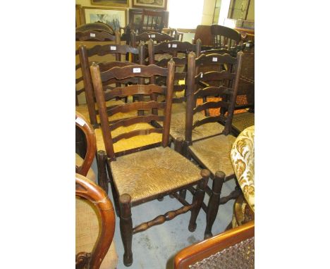 Set of six 19th Century oak ladder back kitchen chairs with rush seats and turned supports with pad feet