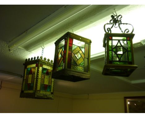 Edwardian brass hall lantern, the sides inset with leaded coloured glass panels, together with two others similar