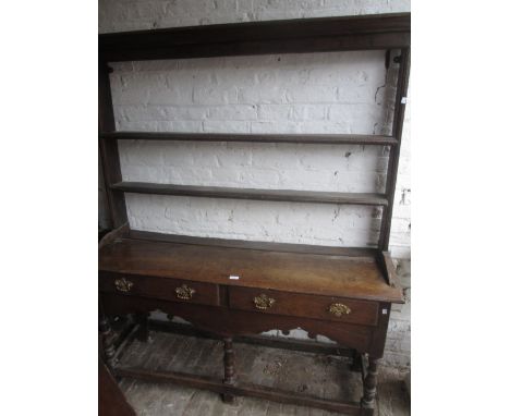 Antique oak dresser, the open shelf back above two drawers with brass handles on baluster turned front supports with stretche