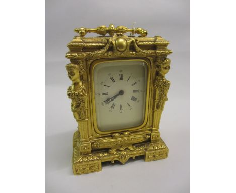 Ornate gilt metal cased carriage clock with enamel dial, Arabic and Roman numerals and single train movement