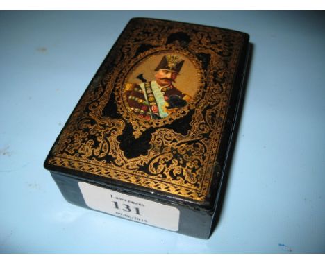 Russian black lacquer papier mache snuff box, the hinged cover decorated with a printed portrait, printed inscription beneath