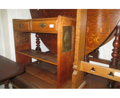 Oak Art Nouveau hanging wall shelf having two drawers above two shelves with embossed copper panels